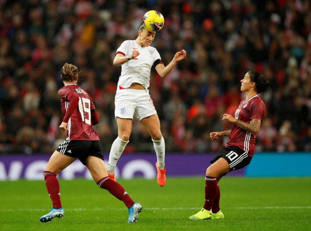 November 9, 2019 England's Lucy Bronze in action with Germany's Dzsenifer Marozsan and Klara Buhl Action Images via Reuters/Andrew Boyers/File Photo