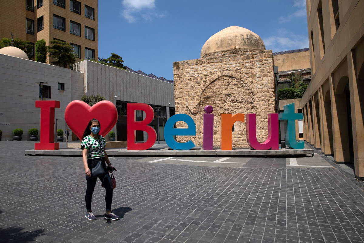 A woman wearing a face mask walks past an 