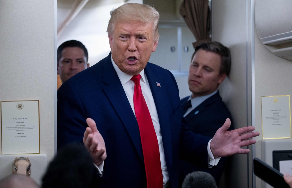 Campaign manager Bill Stepien stands alongside US President Donald Trump as he speaks with reporters aboard Air Force One as he flies from Manchester, New Hampshire to Joint Base Andrews in Maryland, August 28, 2020, following a campaign rally. / AFP / SA