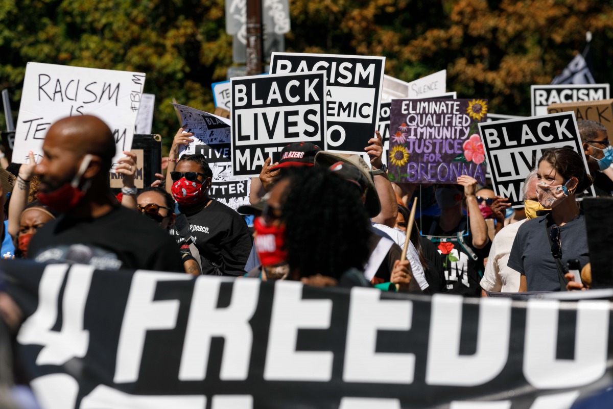 PORTLAND, OREGON, USA - AUGUST 28: Protesters hold banners during a march led by the NAACP and a youth group, Fridays 4 Freedom, to commemorate Martin Luther King’s 1963 Washington DC march, at the Convention Center in Portland, Oregon, on August 28, 2020