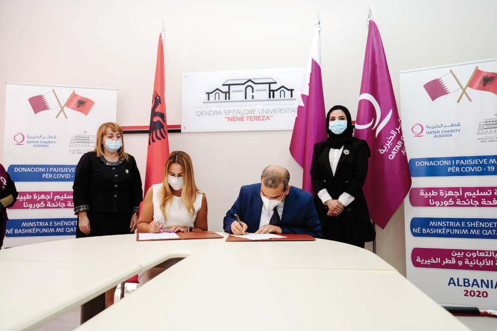 Qatari and Albanian officials signing an agreement to deliver medical devices from Qatar Charity to the Albanian Ministry of Health and Social Protection.
