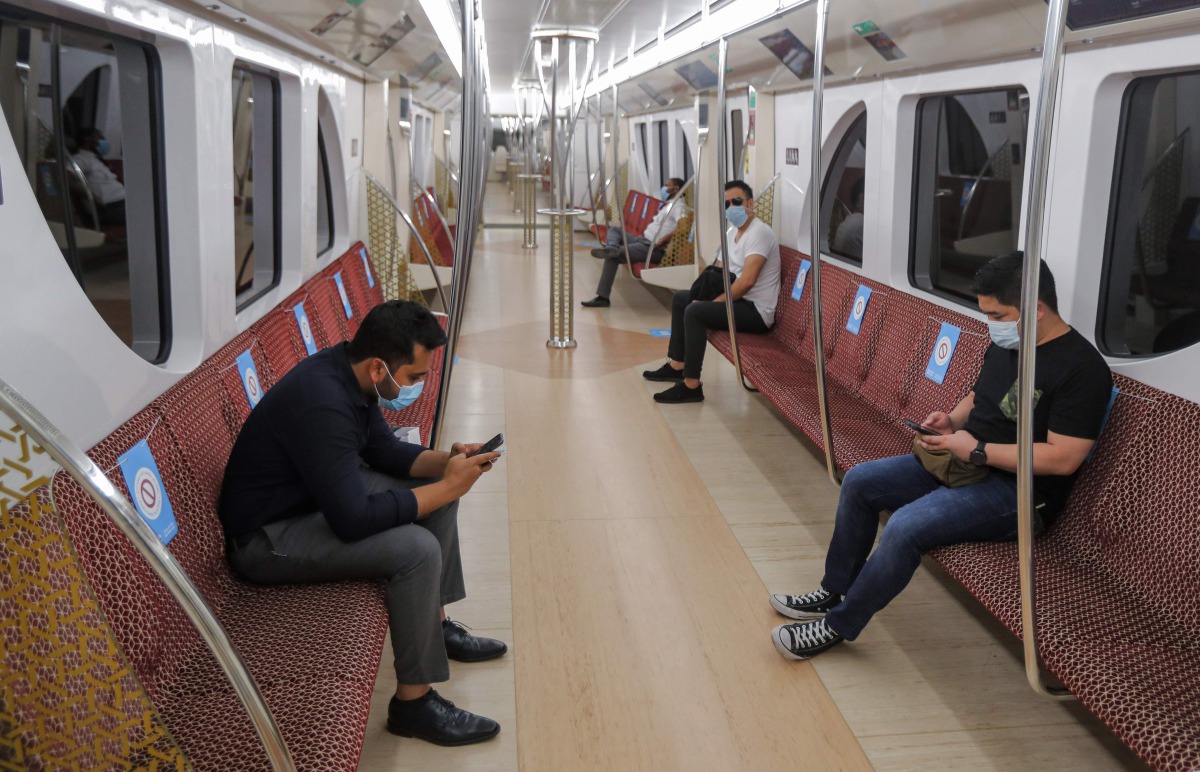 Mask-clad passengers ride in a train of the Doha Metro in Qatar's capital on September 1, 2020, as the Gulf country resumes bus and rail services for the first time since March with reduced capacity due to the COVID-19 coronavirus pandemic. / AFP / KARIM 