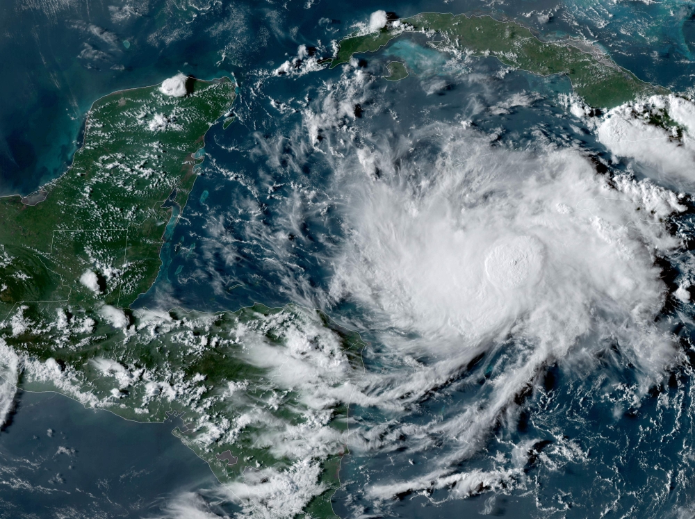 This NOAA/GOES satellite image shows Tropical Storm Nana (R) in the Caribbean at 22:00UTC, on September 1, 2020. Nana will pass near the coast of Honduras on September 2, before intensifying and reaching Belize one day later, the Miami-based National Hurr
