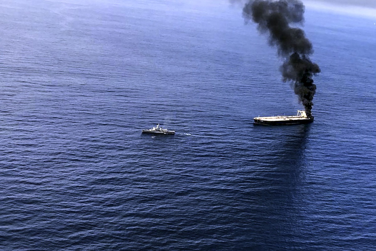 This handout photograph taken on September 3, 2020, and released by Sri Lanka's Air Force, shows black smoke coming out from the Panamanian-registered crude oil tanker, MT New Diamond, some 60 kilometres (38 miles) off Sri Lanka's eastern coast where it r