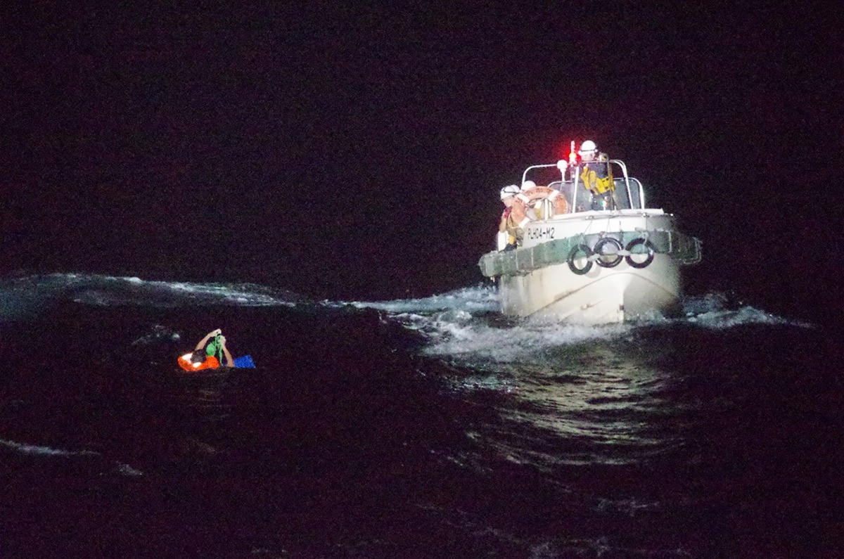 TOPSHOT - This handout picture taken on September 2, 2020 and provided by 10th Regional Coast Guard Headquarters on September 3, 2020 shows coast guards rescuing a Filipino man off Amami Oshima island, about 120 km northwest of the sea. Japan's coast guar
