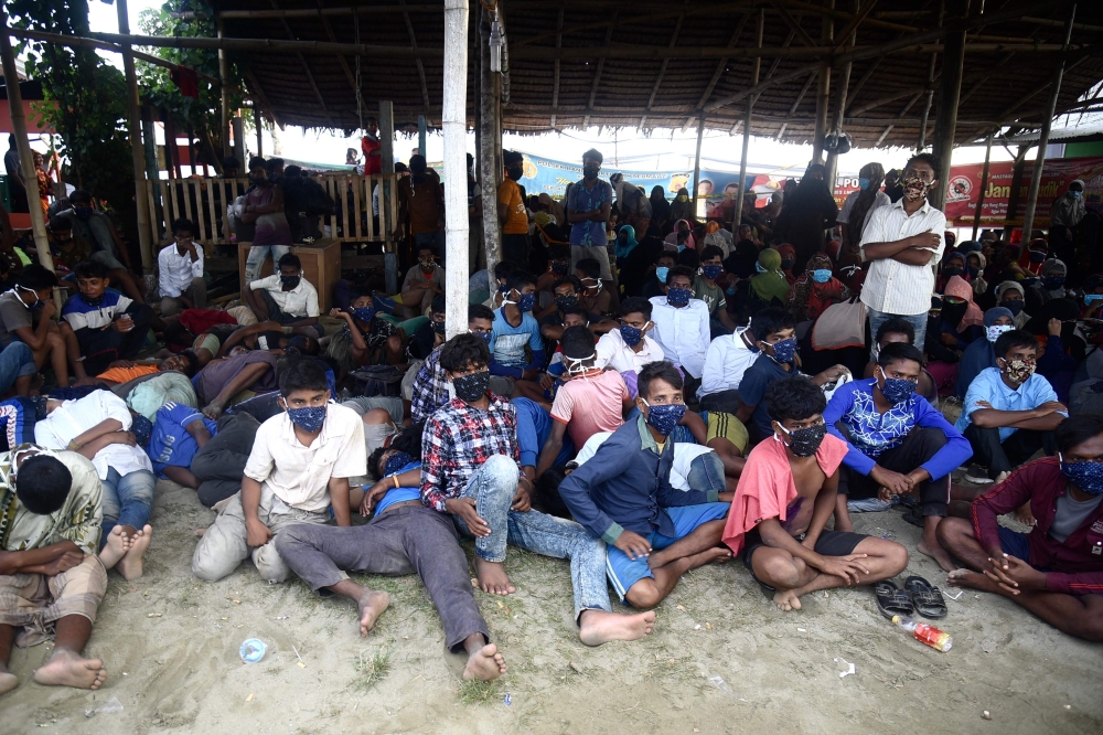 Rohingya migrants look on following their arrival by boat in Lhokseumawe, Aceh on September 7, 2020. AFP / Rahmat Mirza
