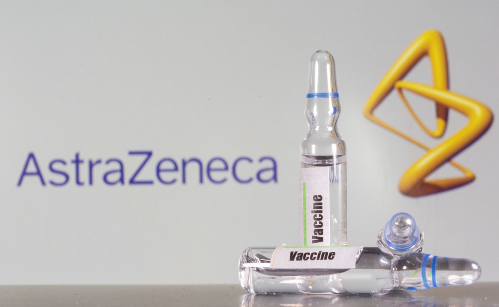 A test tube labelled with the Vaccine is seen in front of AstraZeneca logo in this illustration taken, September 9, 2020. REUTERS/Dado Ruvic/Illustration
