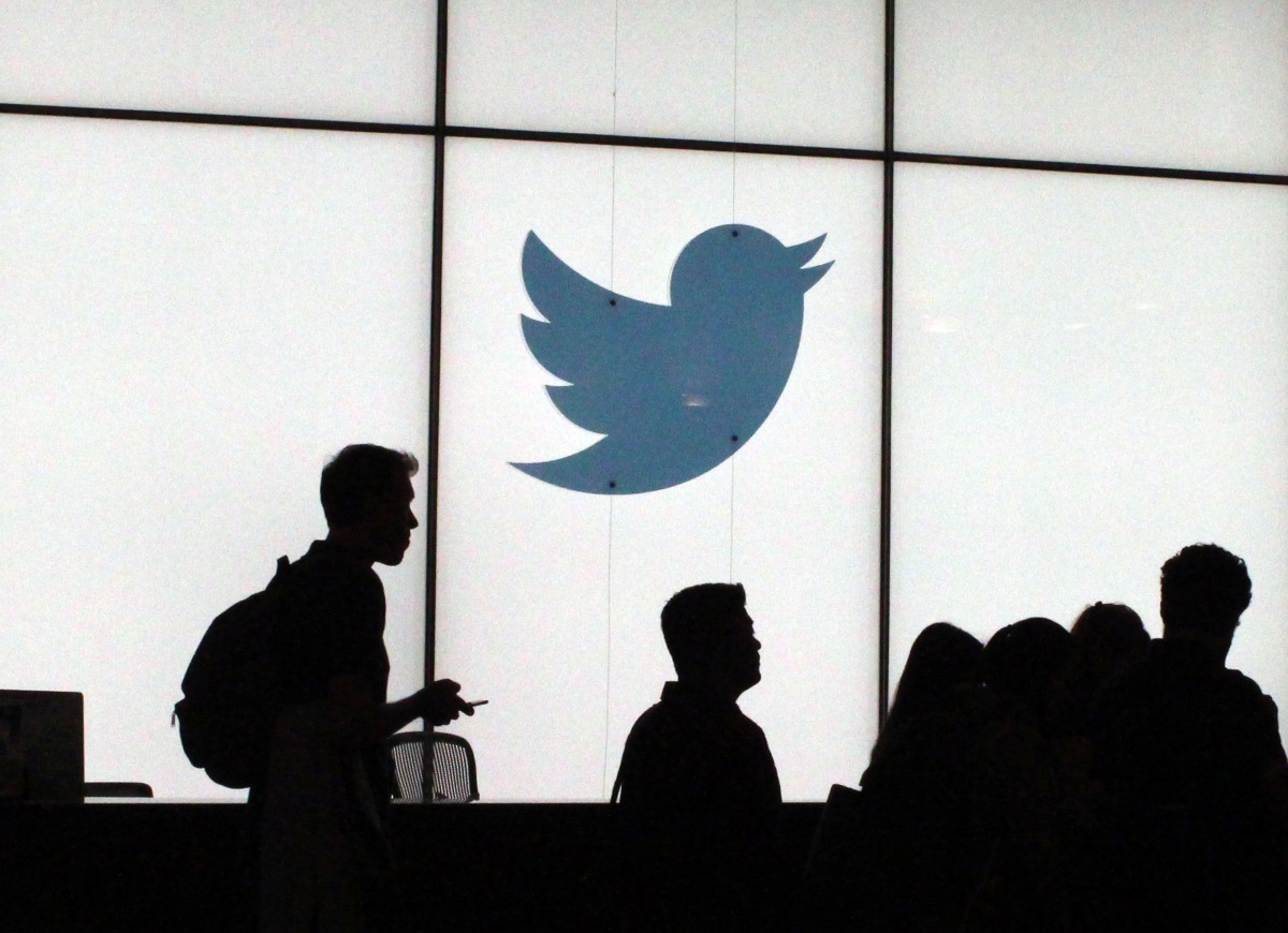 (FILES) In this file photo taken on August 13, 2019, employees walk past a lighted Twitter logo as they leave the company's headquarters in San Francisco. / AFP / Glenn CHAPMAN
