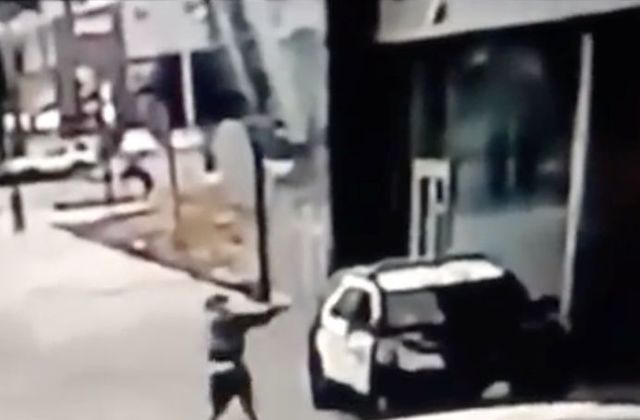 A man aims at a police vehicle in Compton, California, U.S., September 12, 2020 in this still image taken from a video tweeted by the LASD. LOS ANGELES COUNTY SHERIFF'S DEPARTMENT / via REUTERS