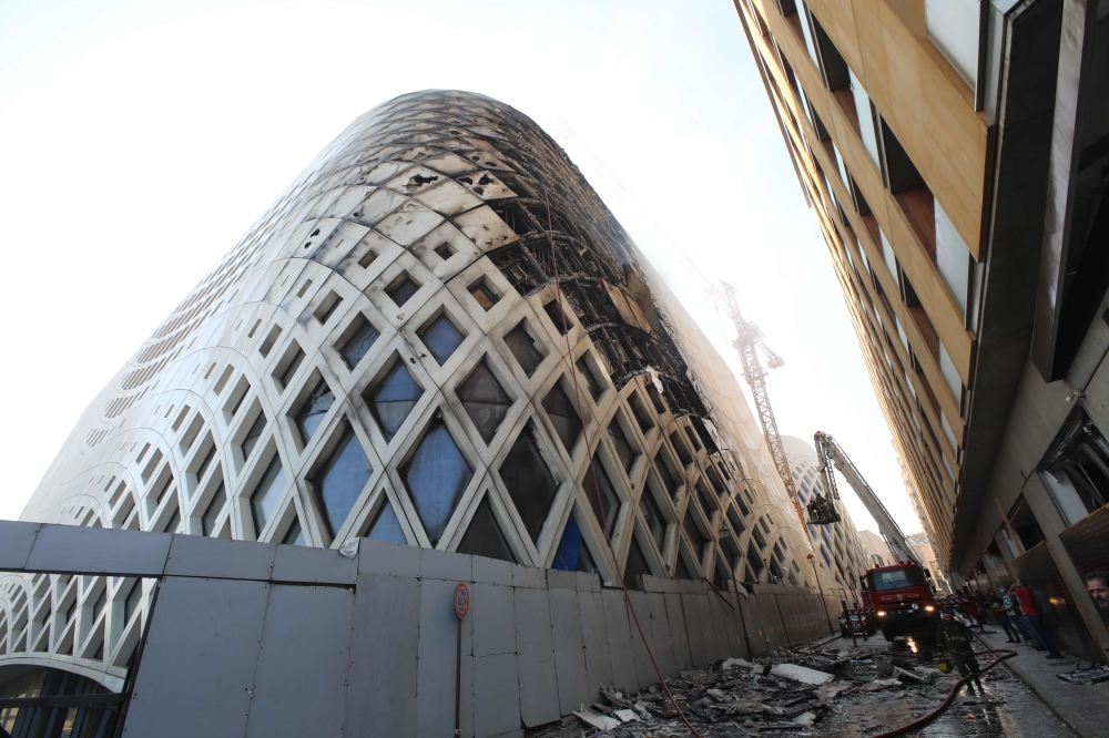 Lebanese firefighters douse the flames of a blaze that engulfed a landmark modern building, designed by the late world-renowned British-Iraqi architect Zaha Hadid, in central Beirut on September 15, 2020 AFP / ANWAR AMRO