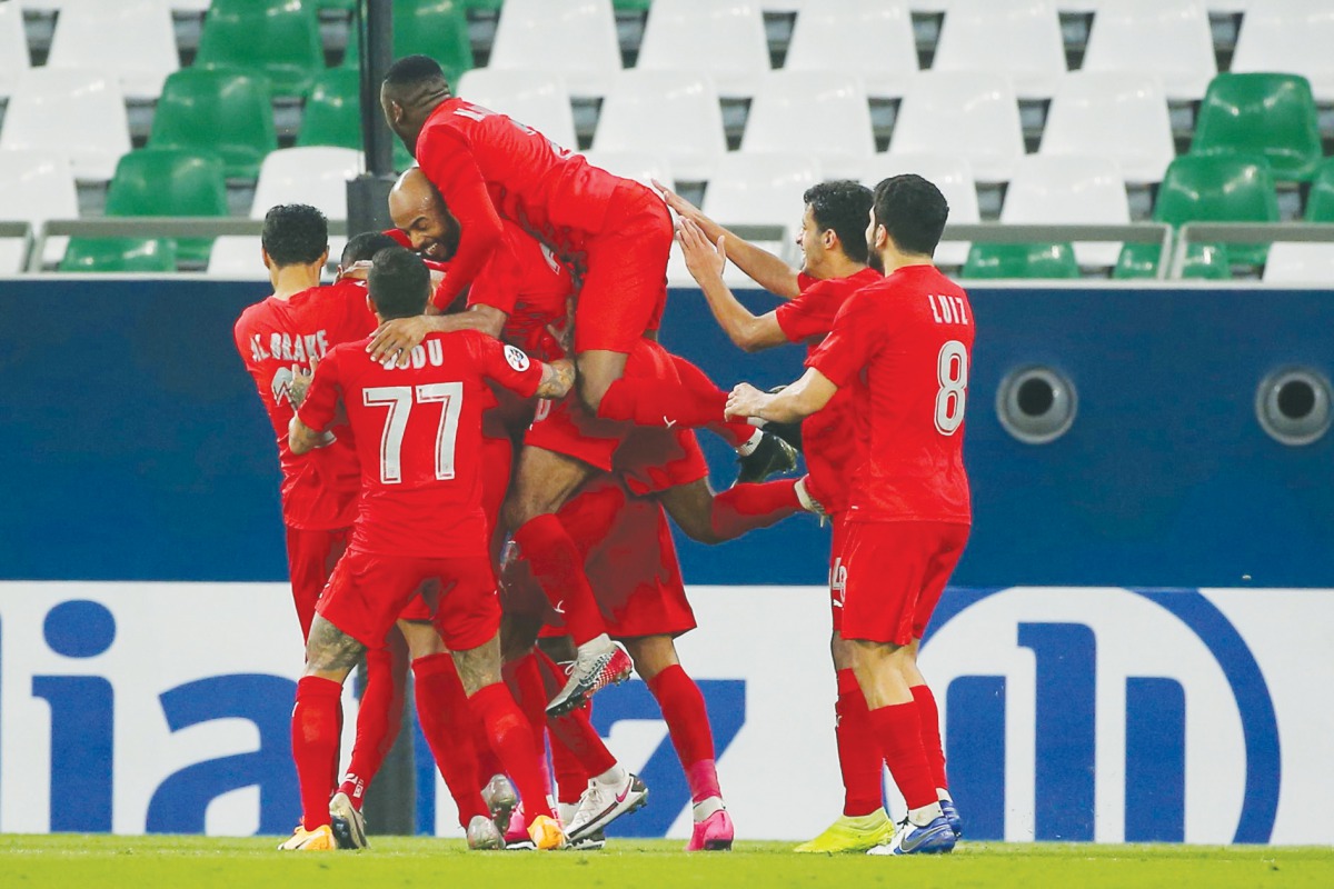 Al Duhail’s players celebrate their goal during the AFC Champions League group C match against UAE’s Sharjah, yesterday. 