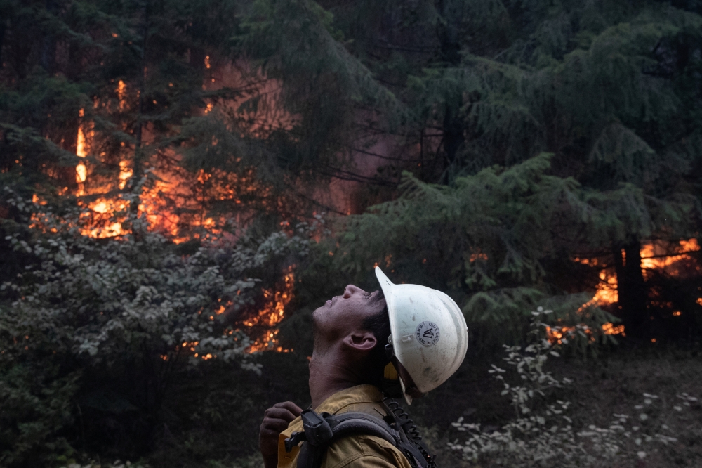 Johnny Islas, a firefighter from Las Vegas, monitors ambers from a firing operation near the Obenchain Fire in Butte Falls, Oregon, U.S., September 15, 2020. REUTERS/Adrees Latif