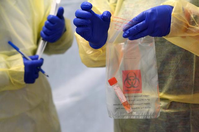 FILE PHOTO: Provincial health workers perform coronavirus disease (COVID-19) tests on residents of the remote First Nations community of Gull Bay, Ontario, Canada April 27, 2020. REUTERS/David Jackson
