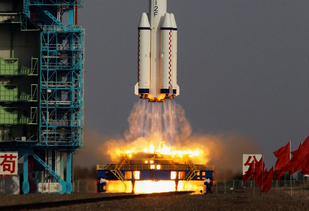 The Long March II-F rocket loaded with a Shenzhou-9 manned spacecraft carrying three Chinese astronauts lifts off from the launch pad in the Jiuquan Satellite Launch Center, Gansu province June 16, 2012. REUTERS/Jason Lee/File Photo