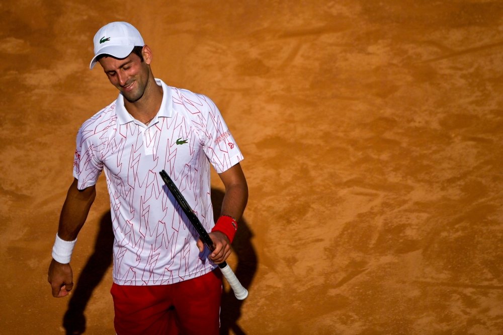 Serbia's Novak Djokovic reacts during his round 3 match against Serbia's Filip Krajinovic on day five of the Men's Italian Open at Foro Italico on September 18, 2020 in Rome, Italy. / AFP / POOL / Riccardo Antimiani