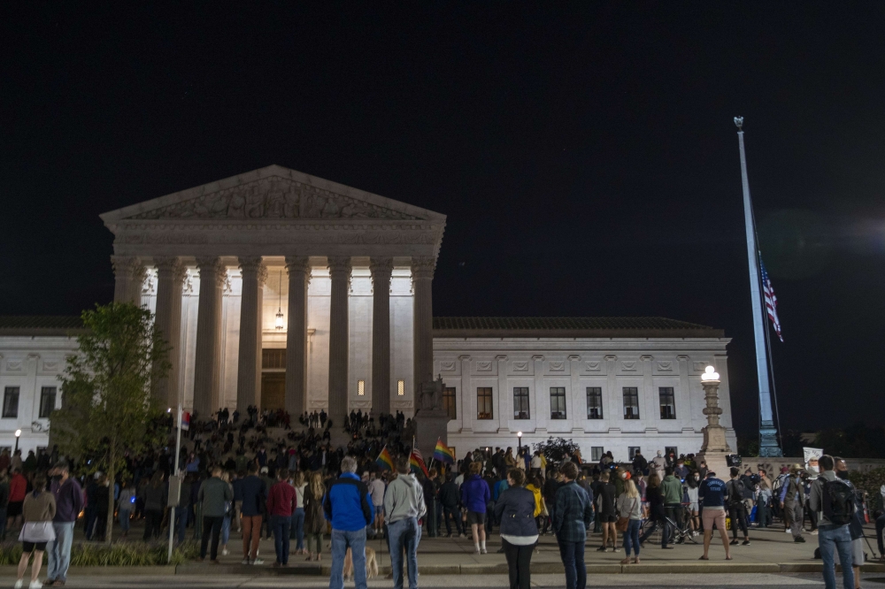 The national flag flies at half staff as people gather to mourn the passing of Supreme Court Justice Ruth Bader Ginsburg at the steps in front of the Supreme Court on September 18, 2020 in Washington, DC. Tasos Katopodis/Getty Images/AFP