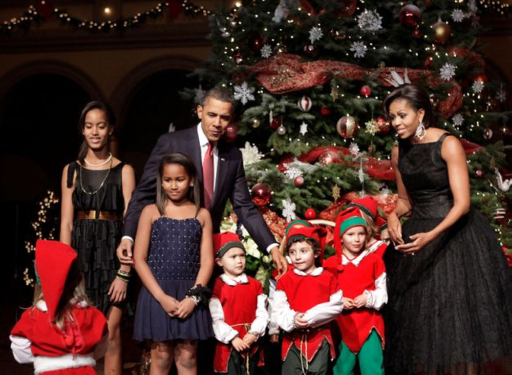 U.S. President Barack Obama, first lady Michelle Obama and their daughters Malia (L), Sasha (2nd L) greet children dressed as elves at the Christmas in Washington Celebration at the National Building Museum in Washington, DC, U.S. December 12, 2010. REUTE