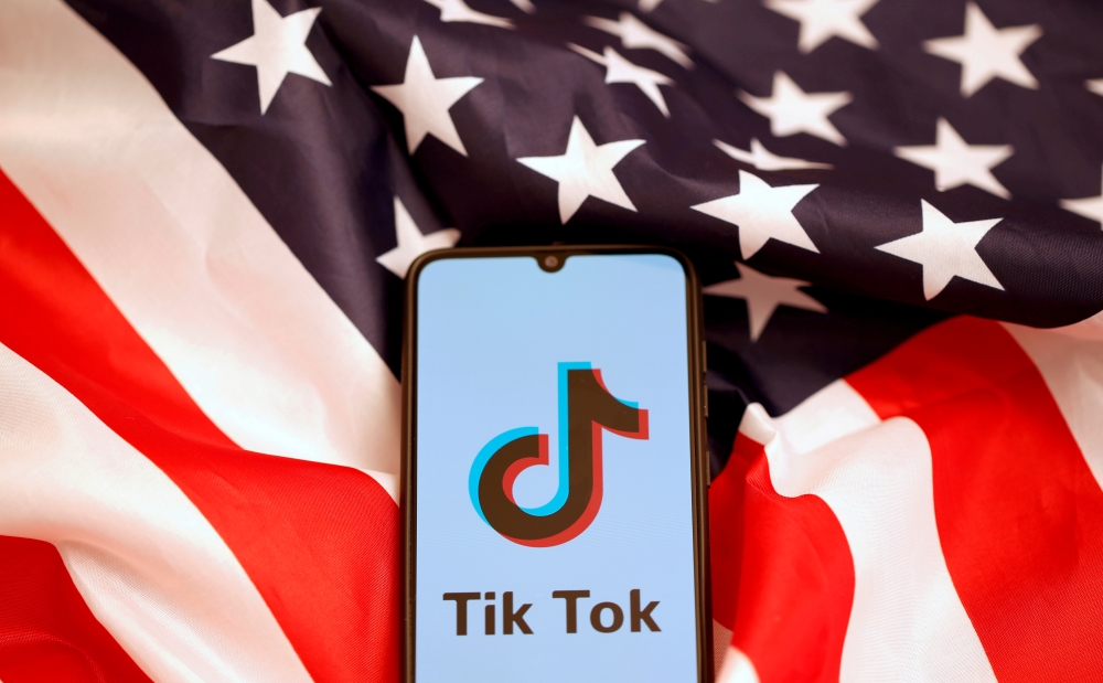 FILE PHOTO: TikTok's logo is displayed on the smartphone while standing on the U.S. flag in this illustration picture taken, November 8, 2019. REUTERS/Dado Ruvic/File Photo
