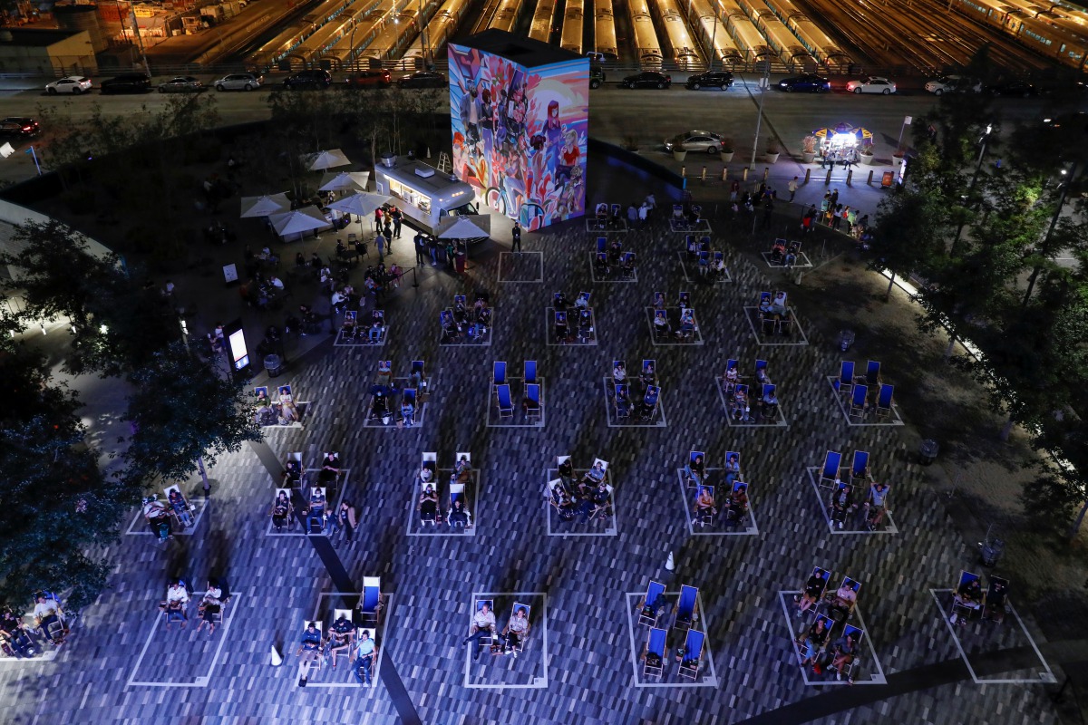 People are seen seated in outlined sections, created to promote social distancing as an attempt to fight the spread of the coronavirus disease (COVID-19), while viewing a screening as part of Movie Nights with Tribeca Film Festival at the Backyard At Huds