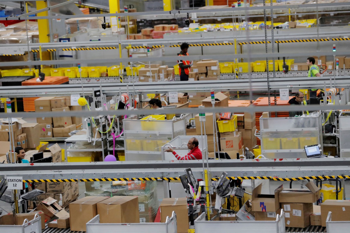 FILE PHOTO: Amazon workers perform their jobs inside an Amazon fulfillment center on Cyber Monday in Robbinsville, New Jersey, U.S., December 2, 2019. REUTERS/Lucas Jackson/File Photo
