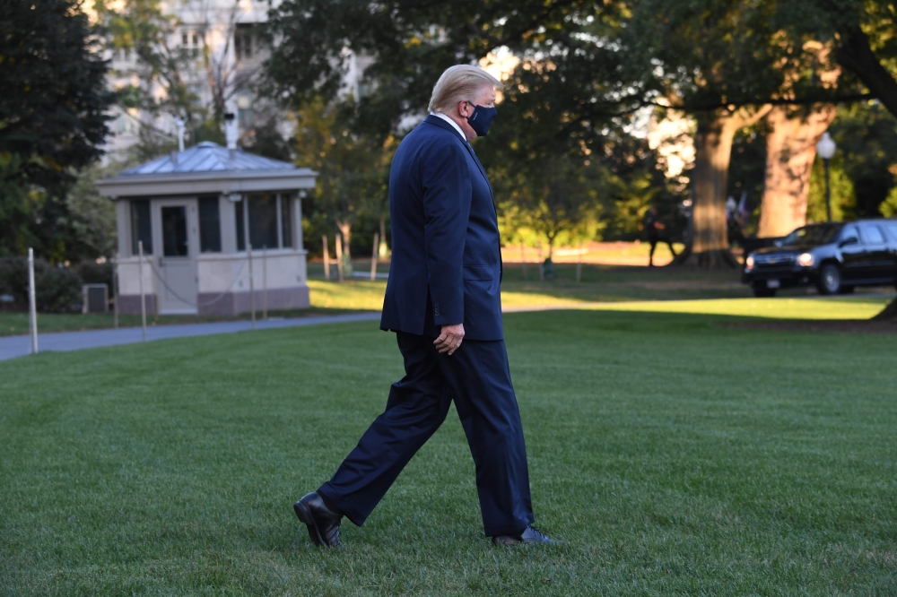 US President Donald Trump walks to Marine One prior to departure from the South Lawn of the White House in Washington, DC, October 2, 2020, as he heads to Walter Reed Military Medical Center, after testing positive for Covid-19. (AFP / SAUL LOEB)
