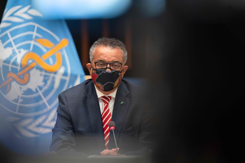 WHO Director-General Tedros Adhanom Ghebreyesus wearing a protective face mask attending a WHO executive board holds a special session on the Covid-19 response at the health agency's headquarters in Geneva, on October 5, 2020. AFP PHOTO / WHO / CHRISTOPHE