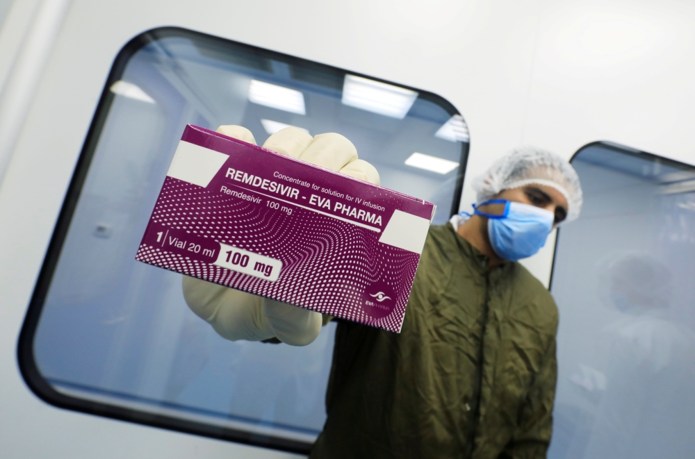 File photo: A lab technician shows the coronavirus disease (COVID-19) treatment drug 