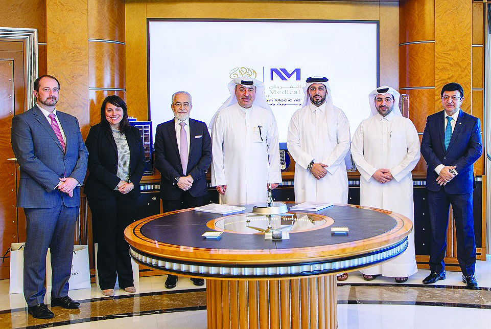 QLM and AMNM officials during the agreement signing event. 