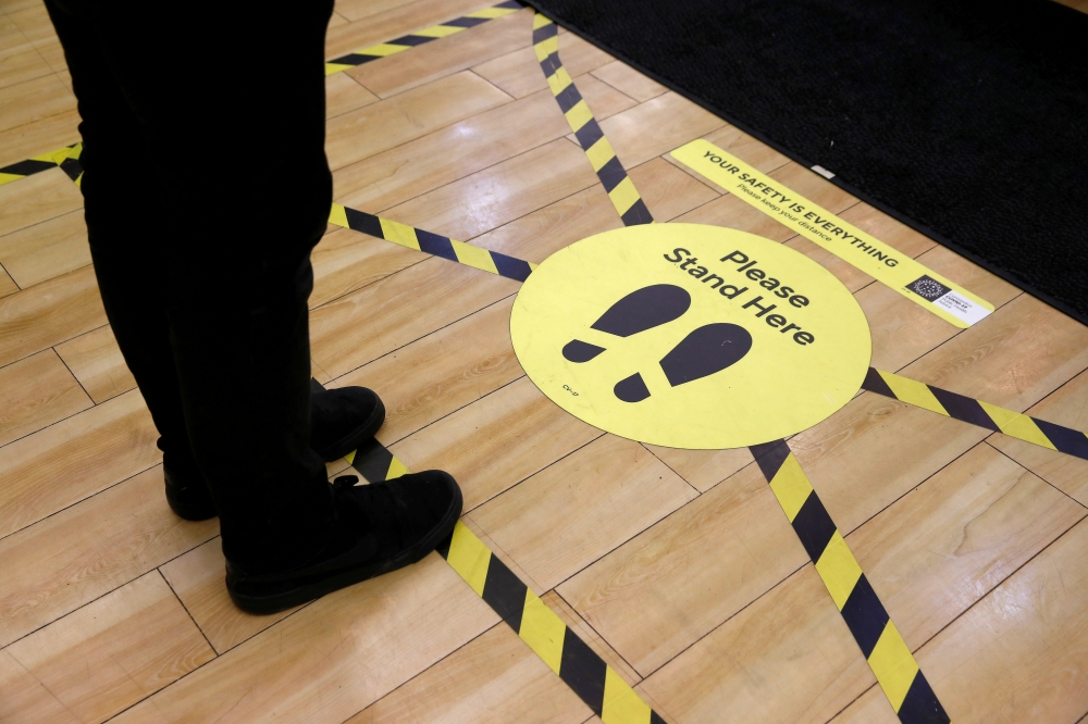 Social distancing markers as a preventive measure against the spread of the coronavirus disease (COVID-19) are seen at a Dunnes Stores shop in Belfast, Northern Ireland, May 6, 2020. Picture taken May 6, 2020. REUTERS/Jason Cairnduff/File Photo