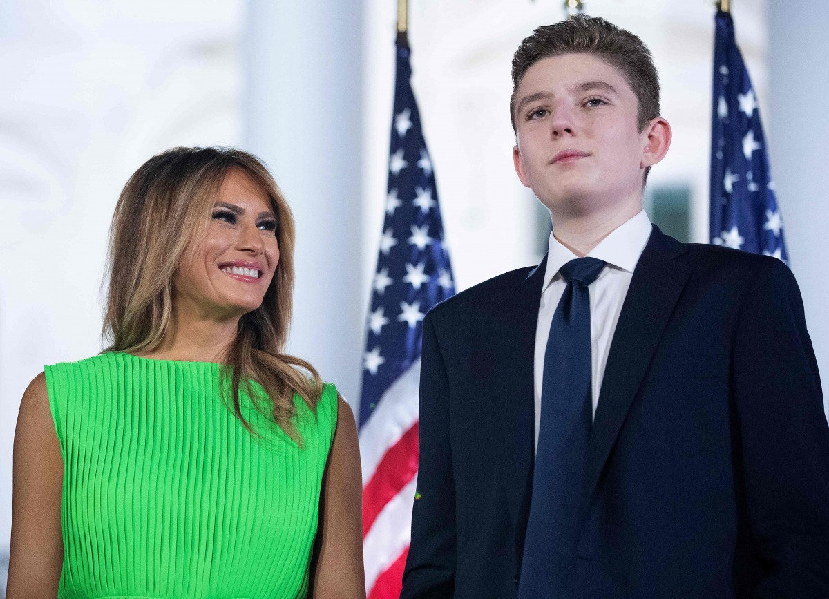 (FILES) In this file photo taken on August 27, 2020, US First Lady Melania Trump (L) looks at her son Barron Trump after US President Donald Trump delivered his acceptance speech for the Republican presidential nomination on the South Lawn of the White Ho