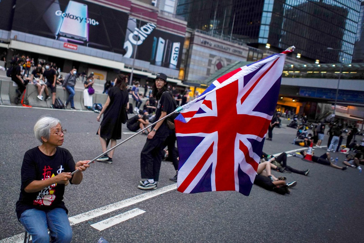 Alexandra Wong, 63, holds up a Union Flag during a demonstration demanding Hong Kong's leaders step down and withdraw an extradition bill, in Hong Kong, China, June 17, 2019. REUTERS/Athit Perawongmetha