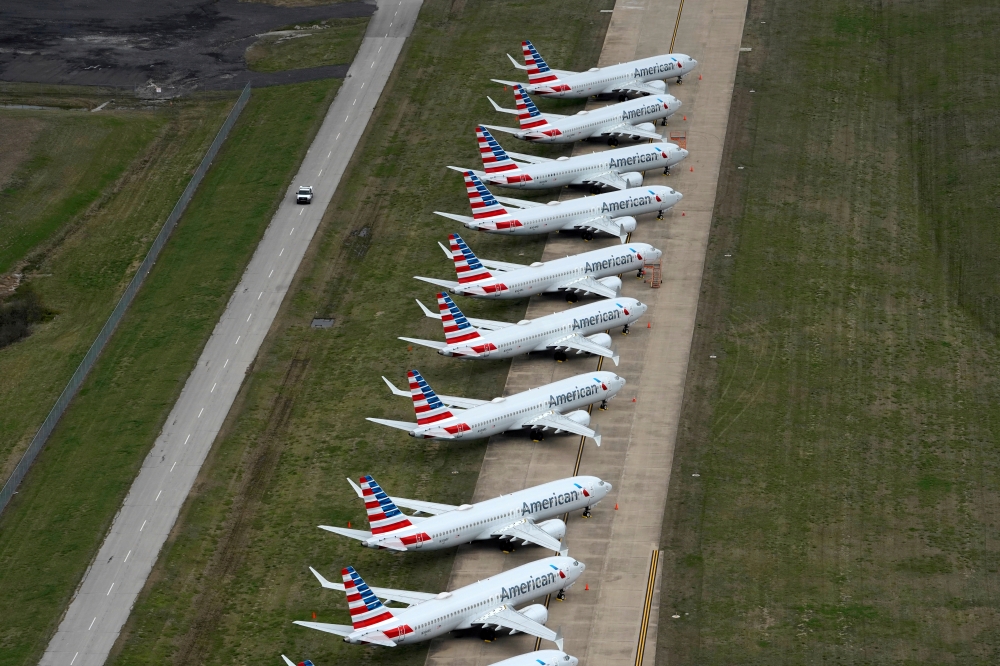 A line of American Airlines Boeing 737 MAX passenger planes are parked on the tarmac at Tulsa International Airport in Tulsa, Oklahoma, U.S., March 23, 2020. REUTERS/Nick Oxford/File Photo