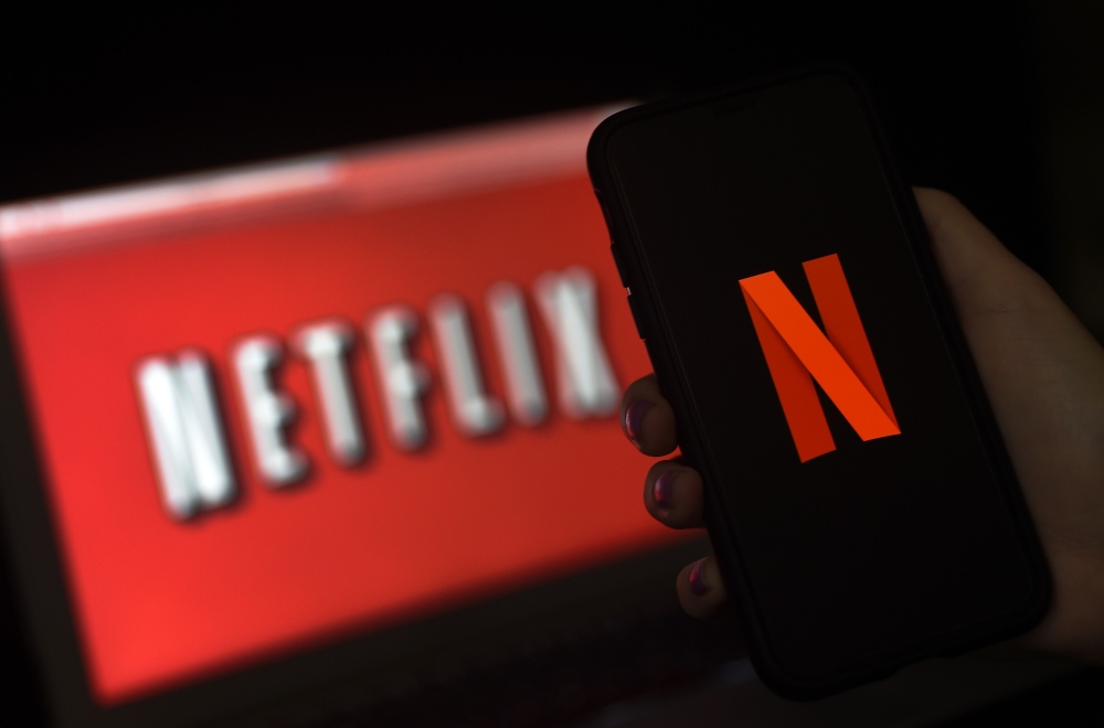 In this file illustration photo taken on March 31, 2020 a computer screen and mobile phone display the Netflix logo in Arlington, Virginia. Netflix shares slid on October 20, 2020 after the US streaming television titan reported that subscriber growth slo