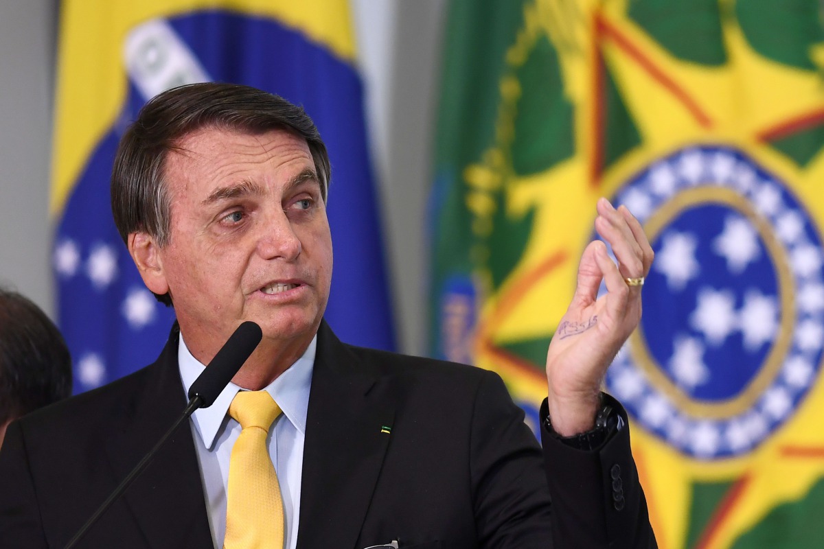 Brazilian President Jair Bolsonaro gestures during an event to announce the clinical study of the use of Nitazoxanide in an early treatment against COVID-19 at Planalto Palace in Brasilia, on October 19, 2020. / AFP / EVARISTO SA
