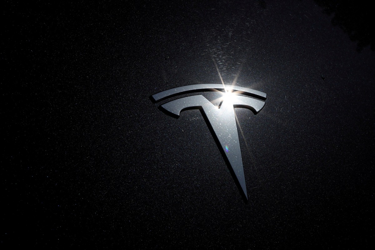 FILE PHOTO: The Tesla logo is seen on a car in Los Angeles, California, U.S., July 9, 2020. REUTERS/Lucy Nicholson/File Photo
