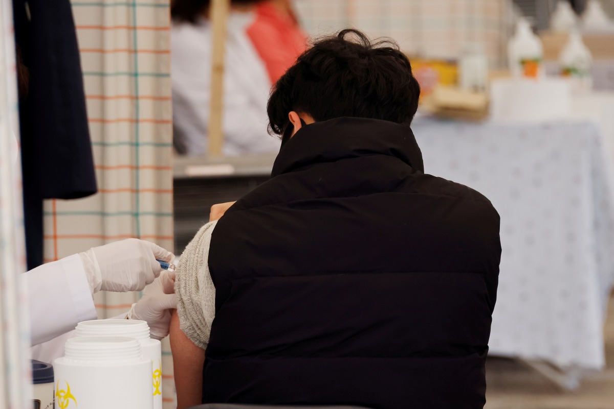 FILE PHOTO: A man gets an influenza vaccine at a hospital in Seoul, South Korea, October 21, 2020. REUTERS/Kim Hong-Ji/File Photo
