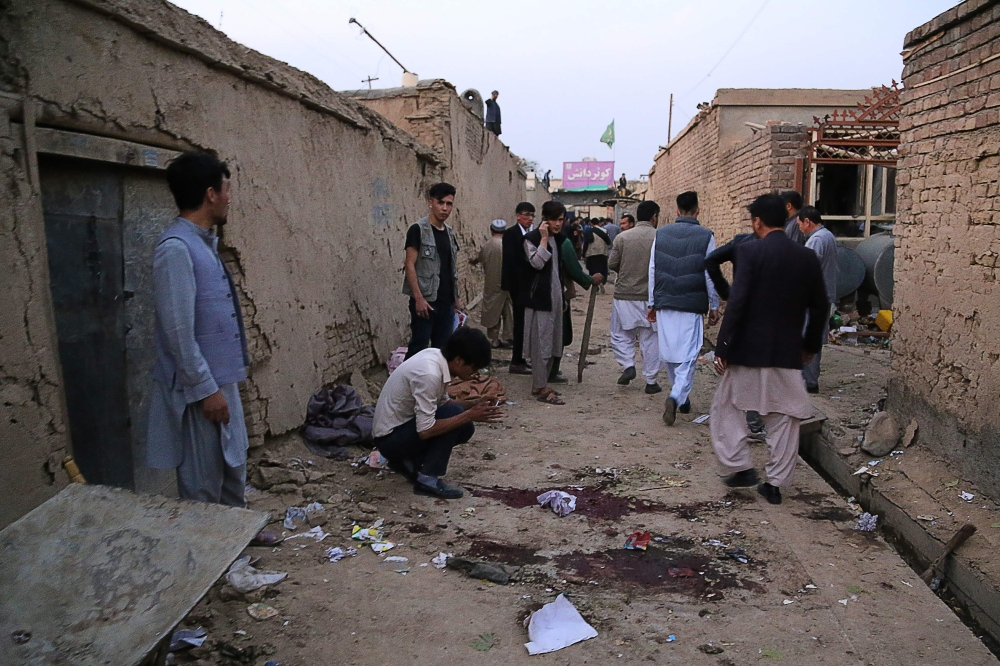 Residents gather at a site following a suicide bomber blew himself up in an education centre, in Kabul on October 24, 2020. A suicide bomber struck near an education centre in the Afghan capital on October 24, killing at least 18 people in the latest atta