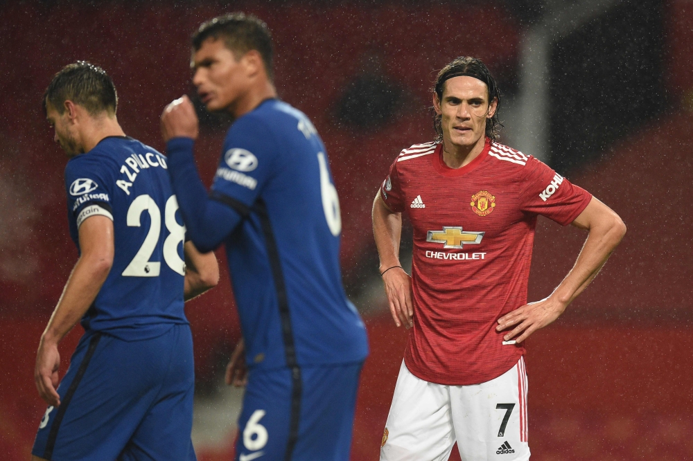 Manchester United's Uruguayan striker Edinson Cavani (R) reacts during the English Premier League football match between Manchester United and Chelsea at Old Trafford in Manchester, north west England, on October 24, 2020. AFP / POOL / Oli SCARFF  