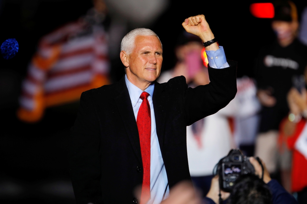U.S. Vice President Mike Pence makes a fist at the end of a rally in Kinston, North Carolina, U.S., October 25, 2020. REUTERS/Jonathan Drake