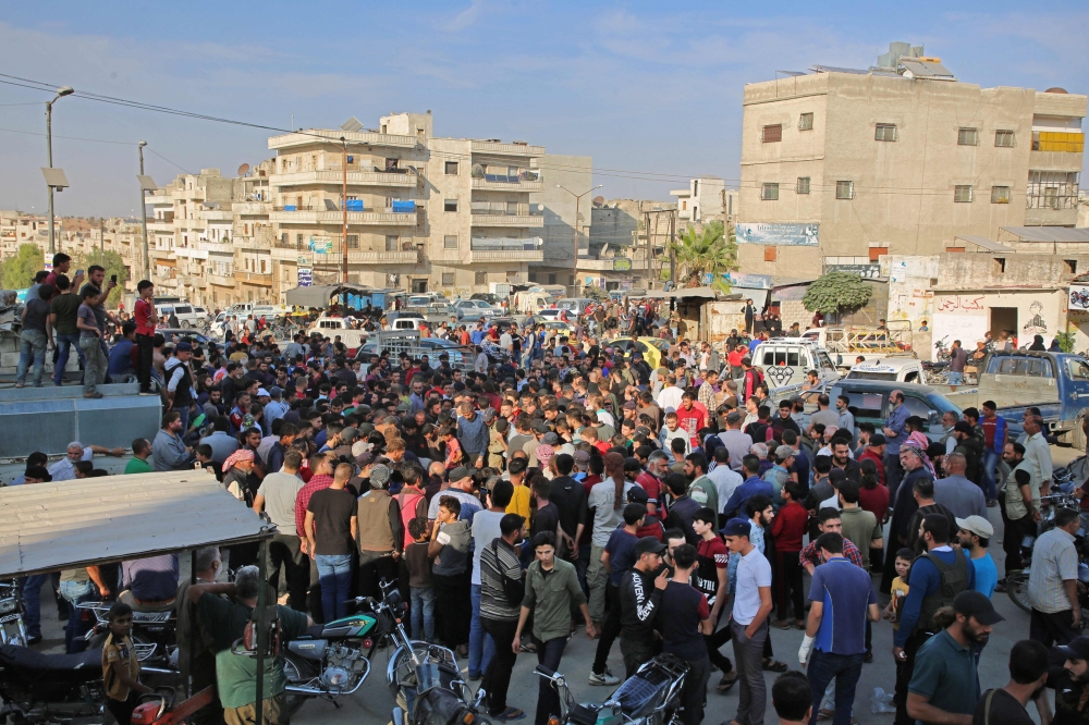 Syrians take part in the funeral of 10 fighters with the Turkey-backed Faylaq al-Sham rebel faction in Syria, in the northwestern city of Idlib, on October 26, 2020, following their death in a Russian air strike.   AFP / Mohammed AL-RIFAI