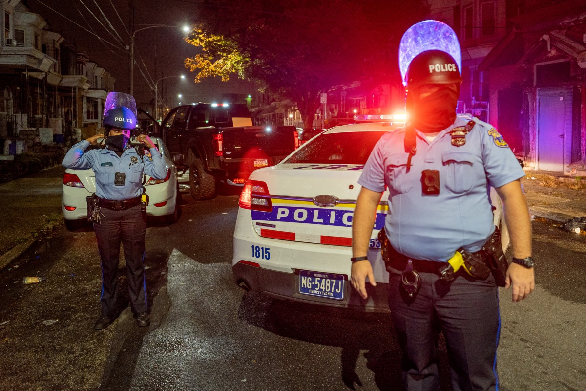 Police officers guard a pick-up truck loaded with looted merchandise following protests over the police shooting death of Walter Wallace in Philadelphia, Pennsylvania, U.S., October 27, 2020. REUTERS/David 'Dee' Delgado
