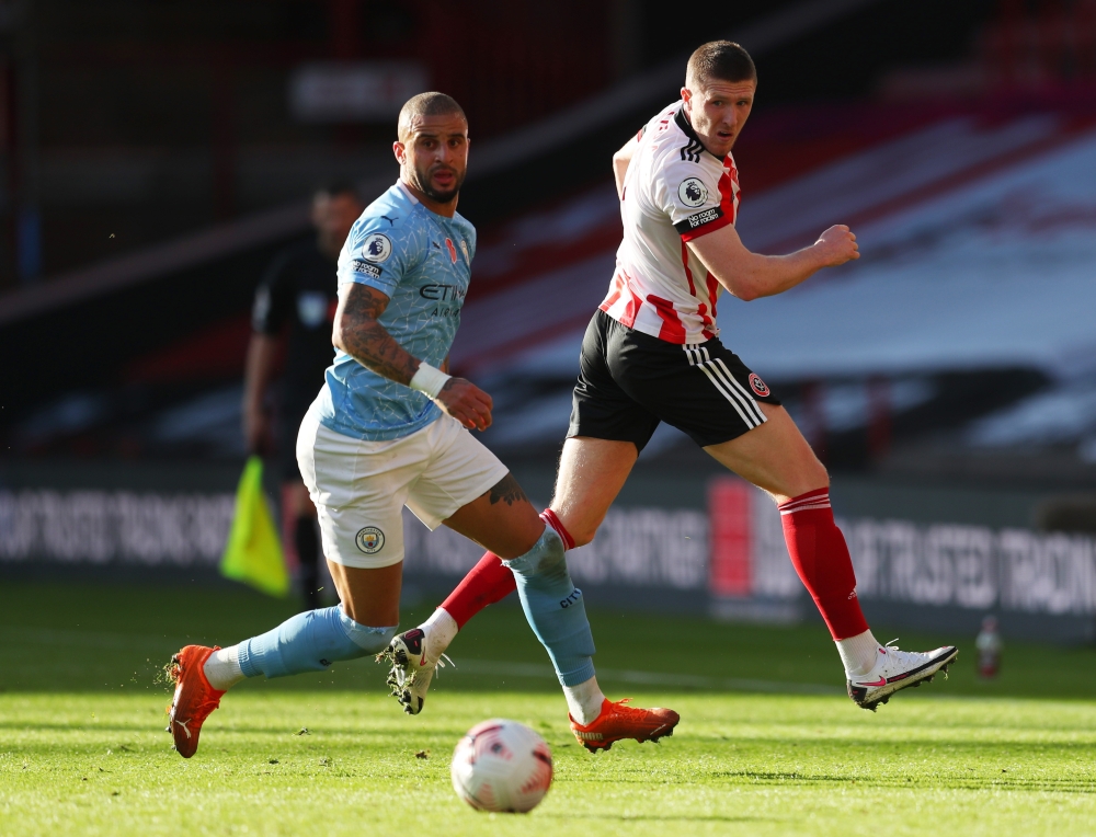 Manchester City's Kyle Walker in action with Sheffield United's John Lundstram Pool via REUTERS/Catherine Ivill 