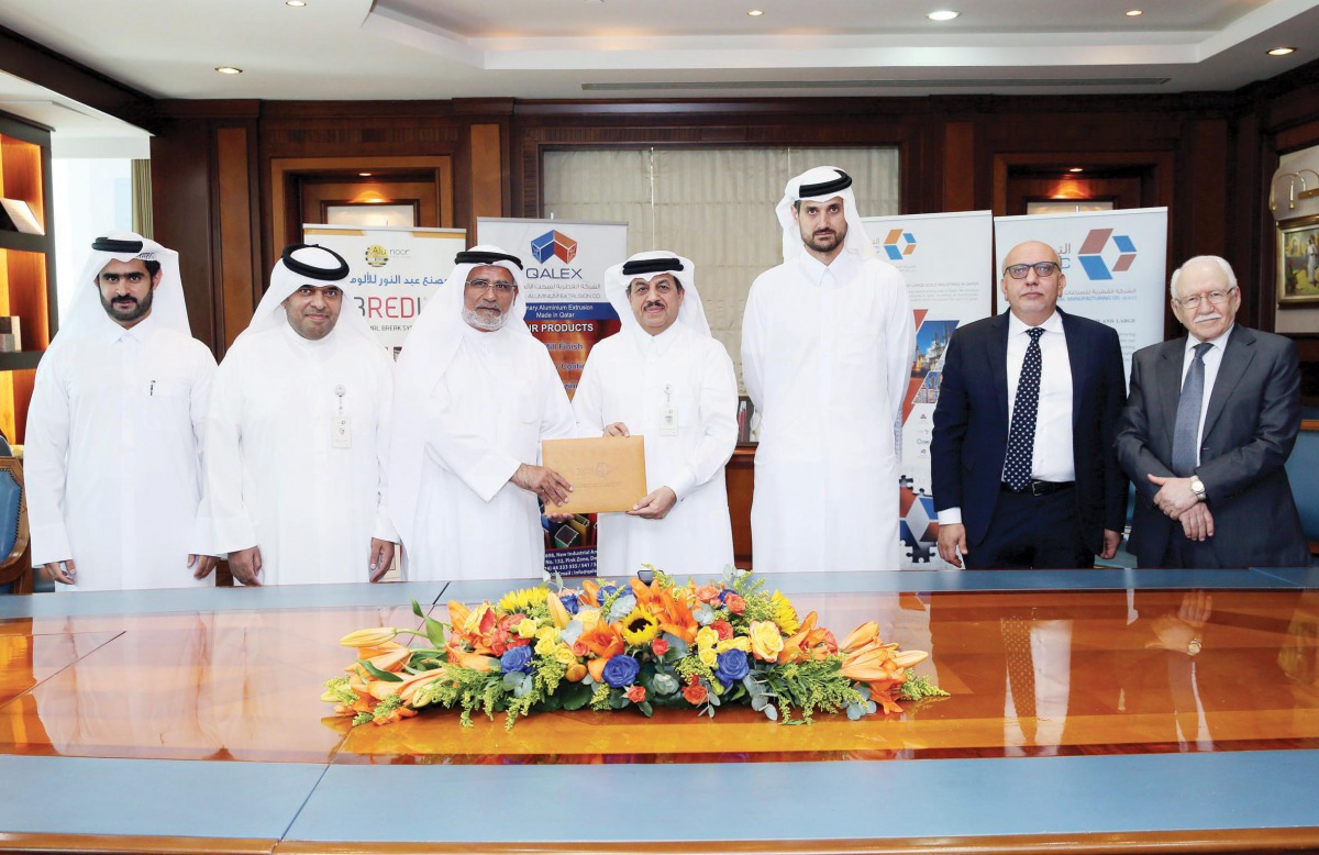 Qatar Aluminium Extrusion Co (QALEX) Chairman, Abdul Rahman bin Abdullah Al Ansari (centre) with other officials at the signing ceremony of the agreement in Doha, recently. 