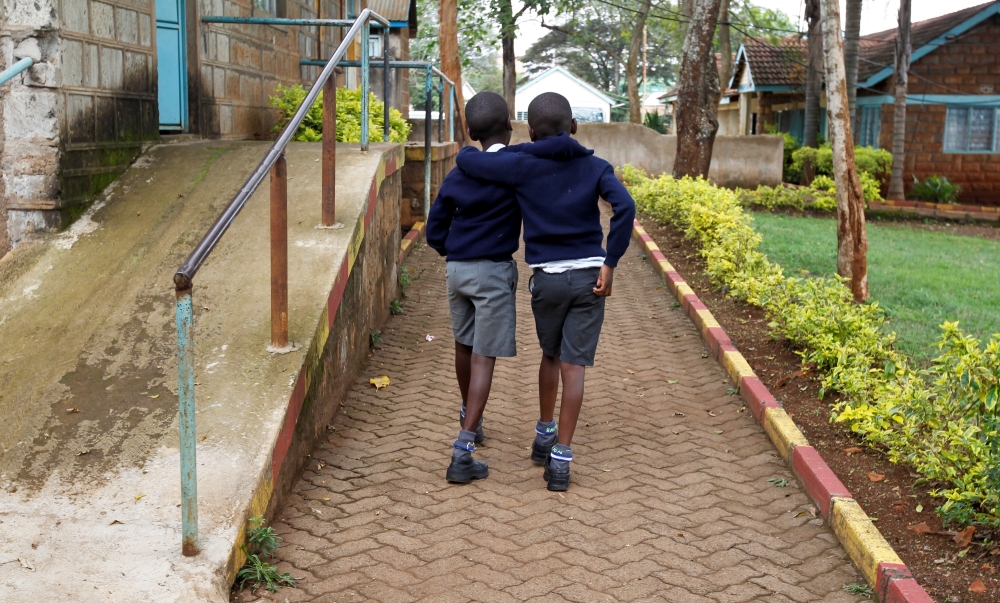 Visually impaired pupils hold on to each other for confidence as they walk after attending a lesson, amid the spread of the coronavirus disease (COVID-19) at the Thika school for the blind in Thika town of Kiambu county, Kenya October 29, 2020. Picture ta
