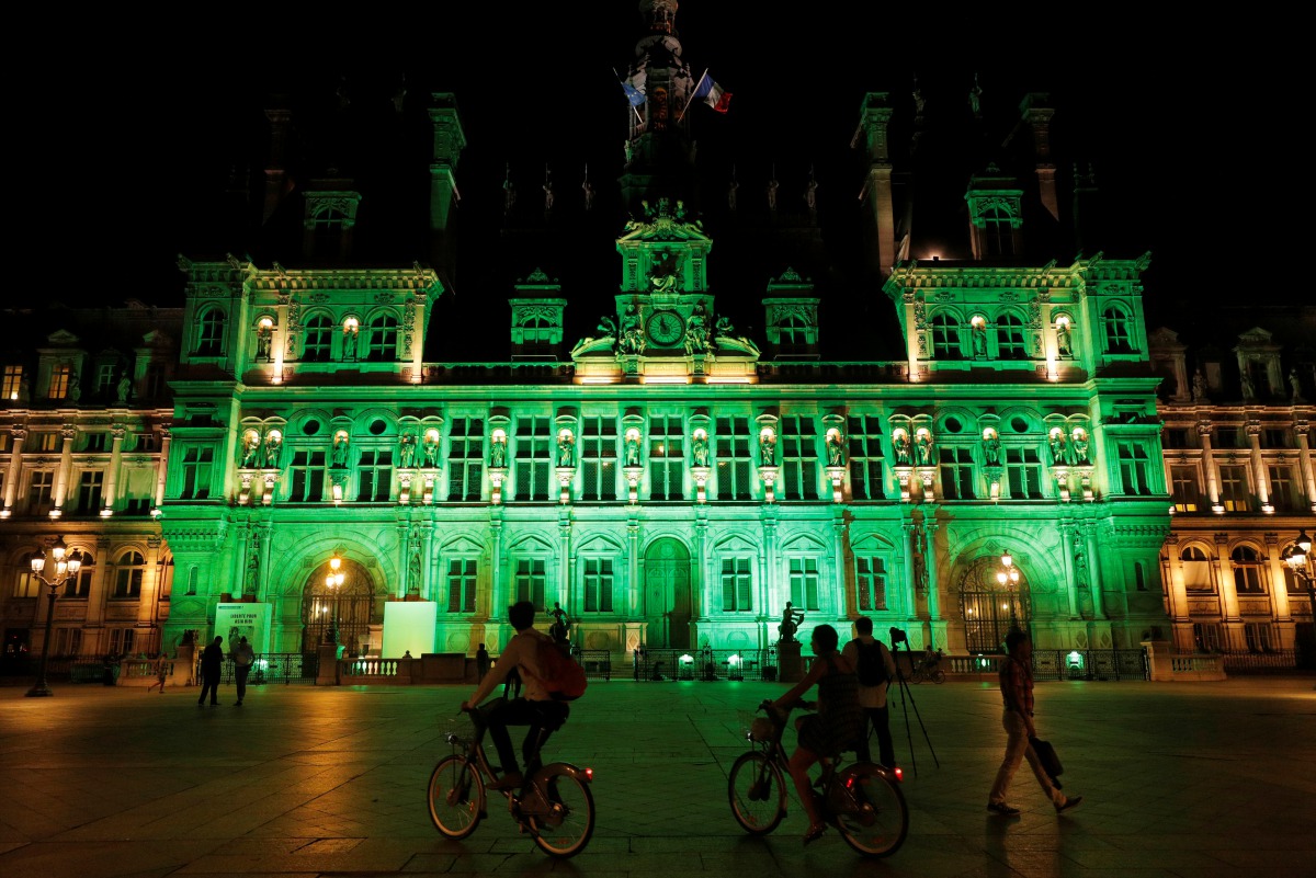 FILE PHOTO: Green lights are projected onto the facade of the Hotel de Ville in Paris, France, after U.S. President Donald Trump announced his decision that the United States will withdraw from the Paris Climate Agreement at a news conference June 1, 2017