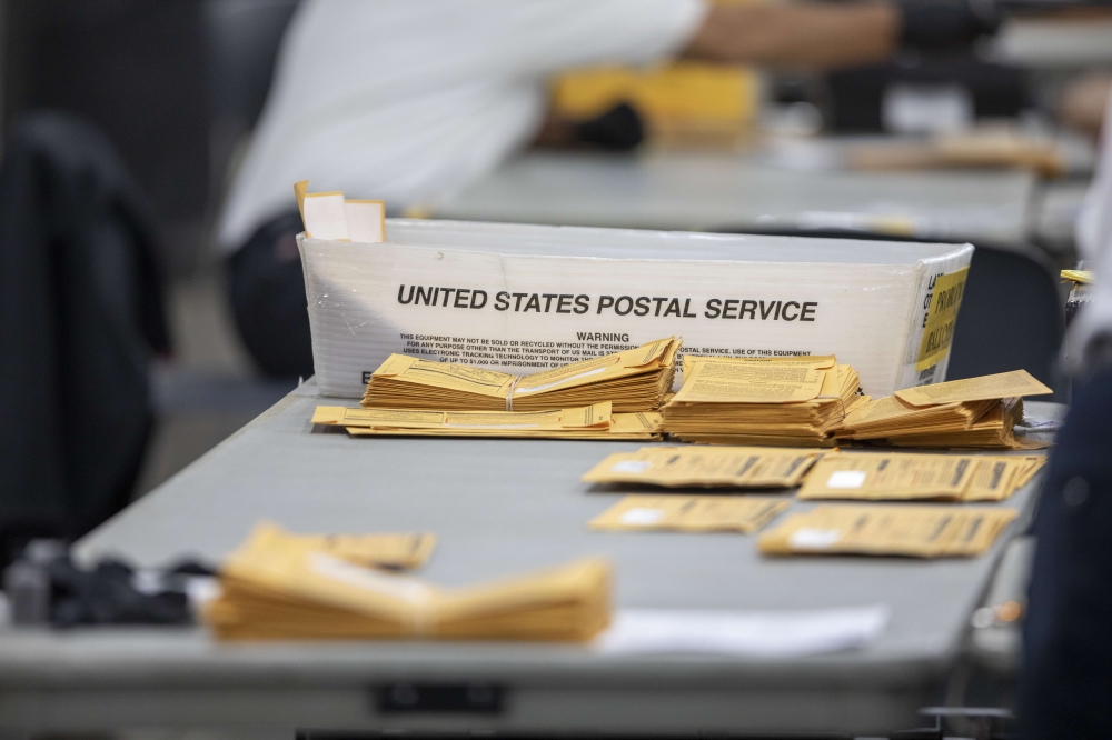 Absentee ballots at the Central Counting Board sit on a desk as they wait to be processed in the TCF Center on November 4, 2020 in Detroit, Michigan. Elaine Cromie/Getty Images/AFP