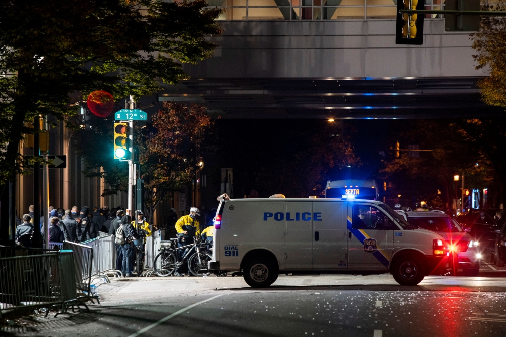 Philadelphia Police officers stand guard near Pennsylvania Convention Center after probing alleged plot to attack vote counting venue of the 2020 U.S. presidential election in Philadelphia, Pennsylvania, U.S. November 6, 2020. REUTERS/Eduardo Munoz