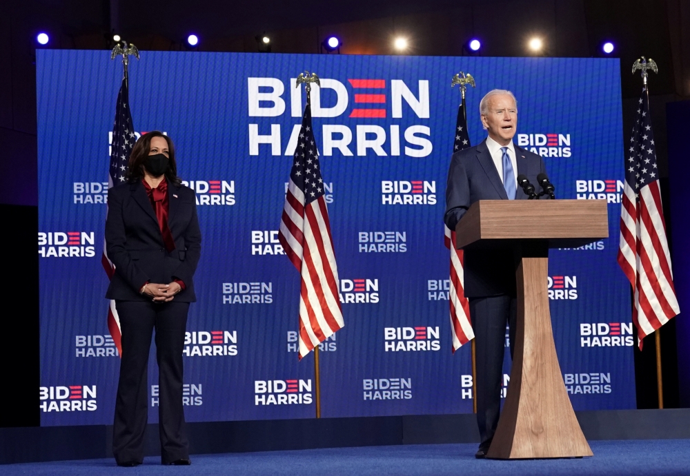 U.S Democratic presidential nominee Joe Biden speaks about election results next to vice presidential nominee Kamala Harris in Wilmington, Delaware, U.S., November 6, 2020. REUTERS/Kevin Lamarque