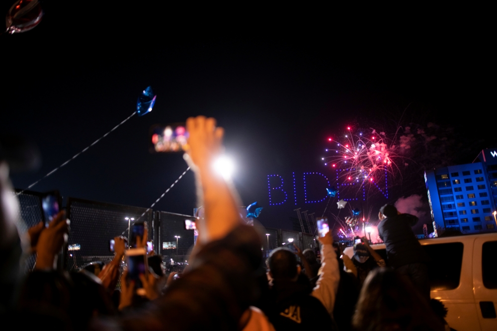 Supporters cheer during fireworks after U.S. President-elect Joe Biden delivered a victory speech, in Wilmington, Delaware, U.S. November 7, 2020. REUTERS/Mark Makela