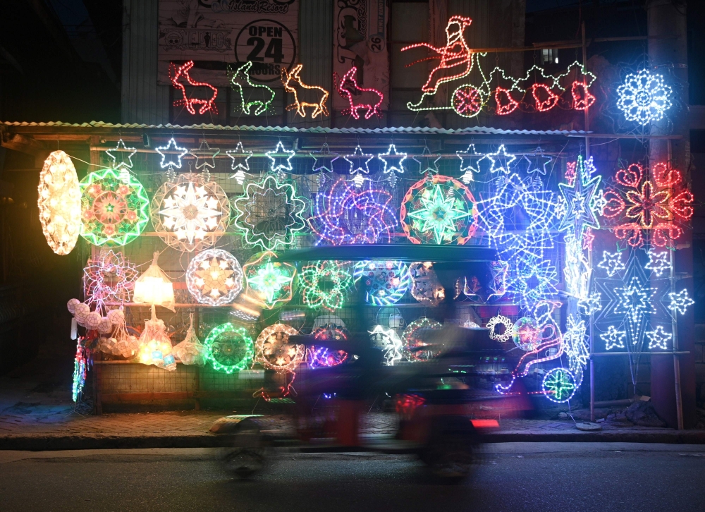 This photo taken on November 5, 2020 shows lanterns and lit ornaments for sale during the festive season at a shop in San Fernando town in Pampanga province. FOCUS BY CECIL MORELLA / AFP / Ted ALJIBE